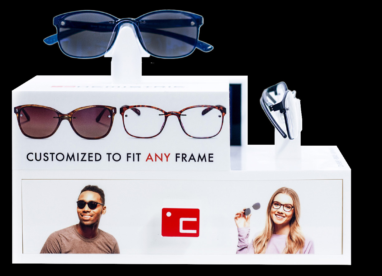Chemistrie counter display showing demo clips mounted on frames with lens sample sheets.