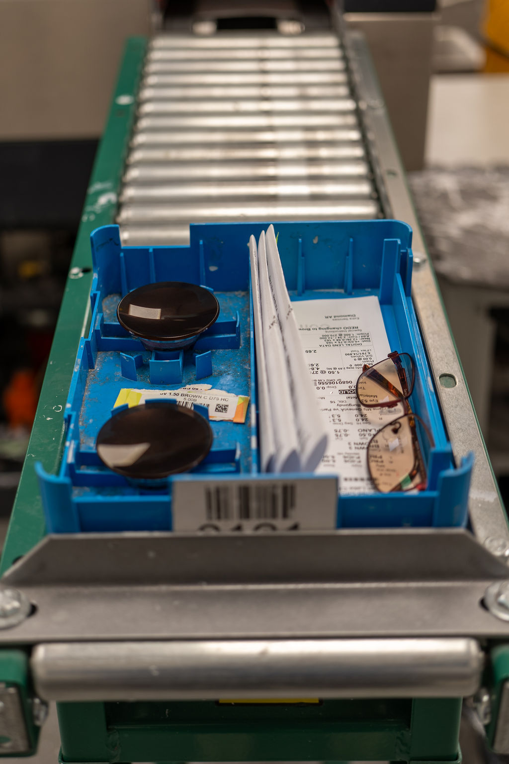 Lens tray with patient ticket moving down the lab conveyor