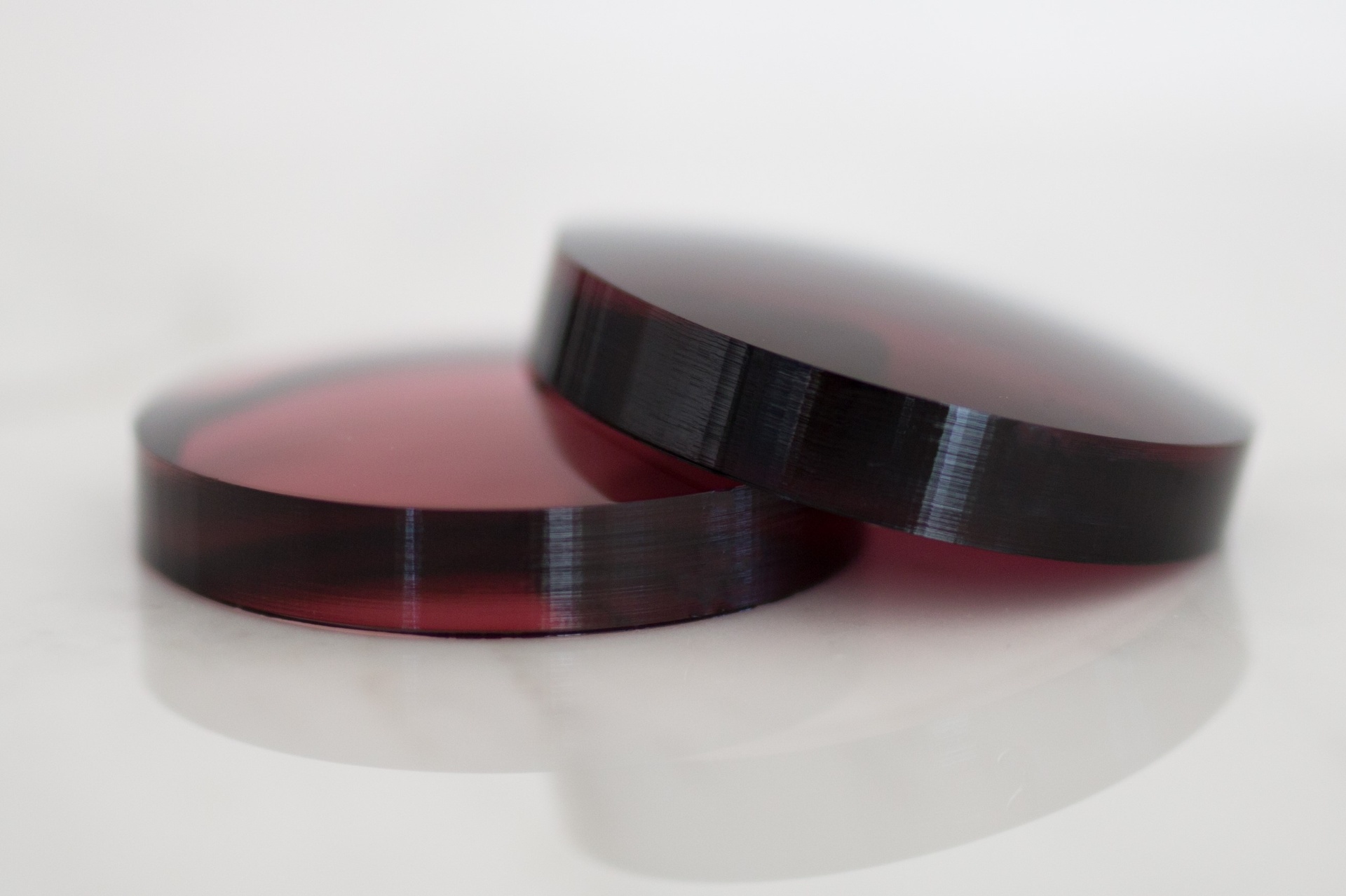 Two Premier FL-41 lens pucks — pre-dyed lens blanks