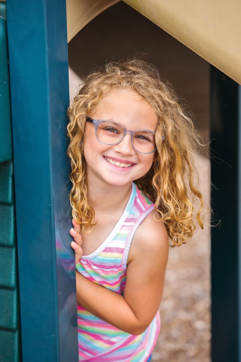 Girl smiling while wearing the Modern Optical Behave frame